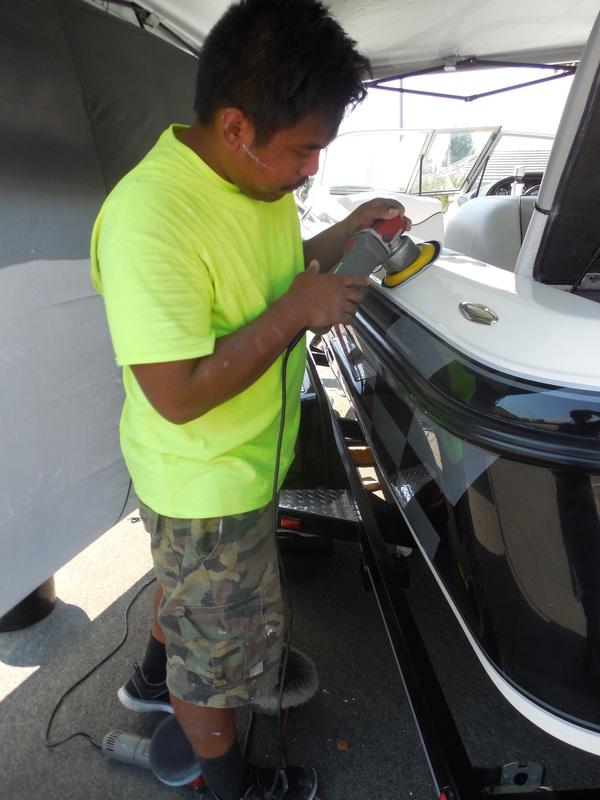 ken of detail pros doing oxidation removal and gel coat restoration on this centurion ski boat in yuba city