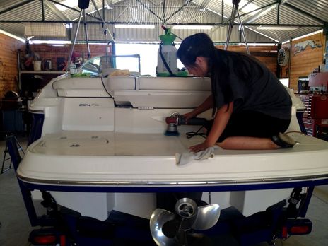 caryn of detail pros cleaning and detaiing a boat in browns valley